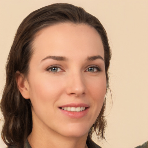 Joyful white young-adult female with medium  brown hair and grey eyes