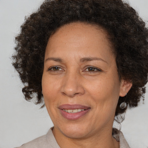 Joyful black adult female with medium  brown hair and brown eyes
