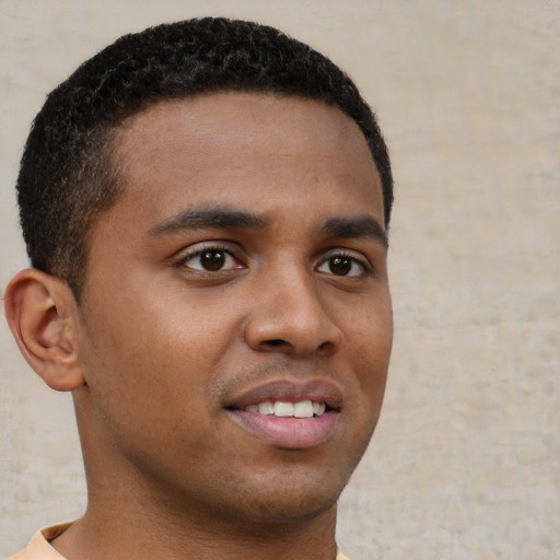 Joyful black young-adult male with short  brown hair and brown eyes
