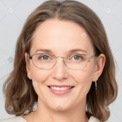 Joyful white adult female with medium  brown hair and grey eyes