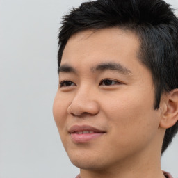 Joyful asian young-adult male with short  black hair and brown eyes