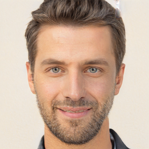 Joyful white adult male with short  brown hair and brown eyes