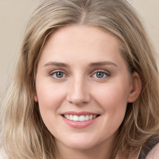 Joyful white young-adult female with long  brown hair and blue eyes