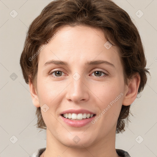 Joyful white young-adult female with medium  brown hair and green eyes