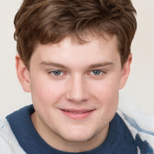 Joyful white young-adult male with short  brown hair and blue eyes