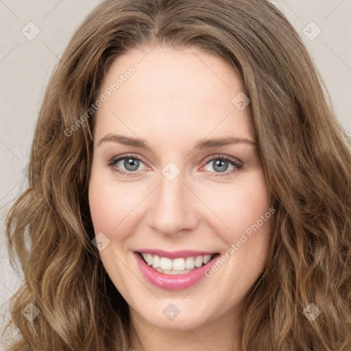 Joyful white young-adult female with long  brown hair and green eyes