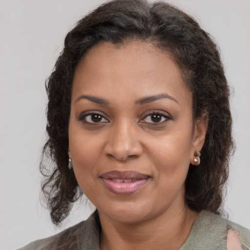 Joyful black young-adult female with medium  brown hair and brown eyes