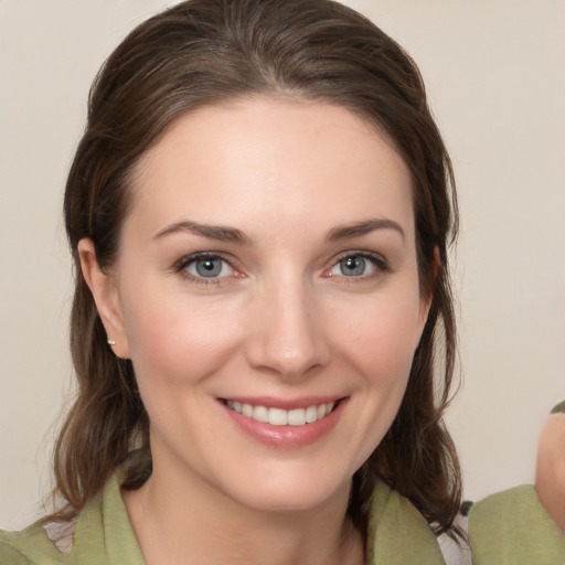 Joyful white young-adult female with medium  brown hair and green eyes