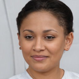 Joyful latino young-adult female with short  brown hair and brown eyes