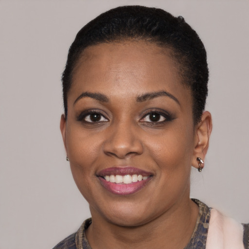 Joyful latino young-adult female with short  black hair and brown eyes