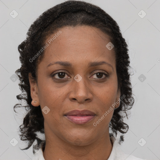 Joyful black adult female with medium  brown hair and brown eyes