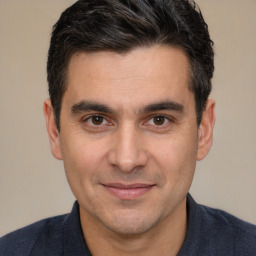 Joyful white adult male with short  brown hair and brown eyes