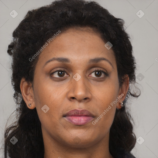 Joyful black young-adult female with long  brown hair and brown eyes