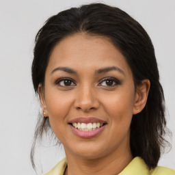 Joyful latino young-adult female with medium  brown hair and brown eyes