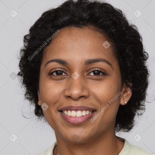 Joyful black young-adult female with long  brown hair and brown eyes