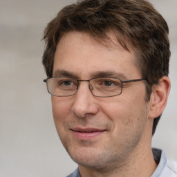 Joyful white adult male with short  brown hair and brown eyes