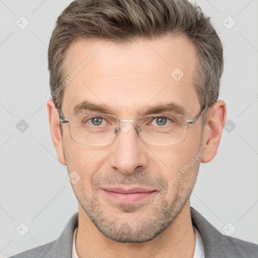 Joyful white adult male with short  brown hair and brown eyes