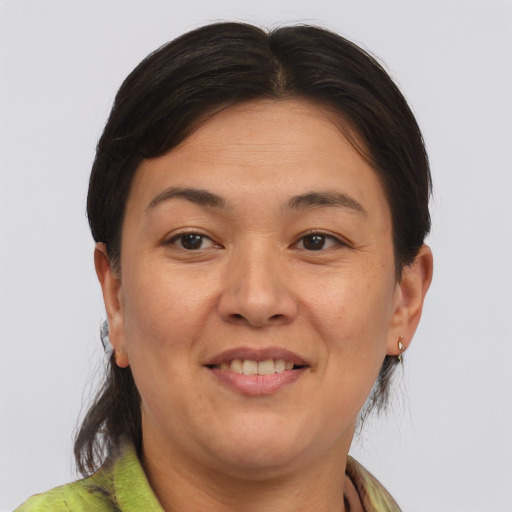 Joyful asian adult female with medium  brown hair and brown eyes
