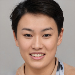 Joyful asian young-adult female with short  brown hair and brown eyes