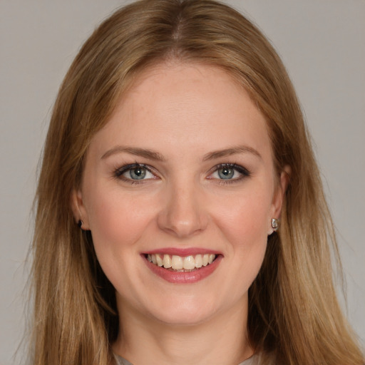 Joyful white young-adult female with long  brown hair and grey eyes