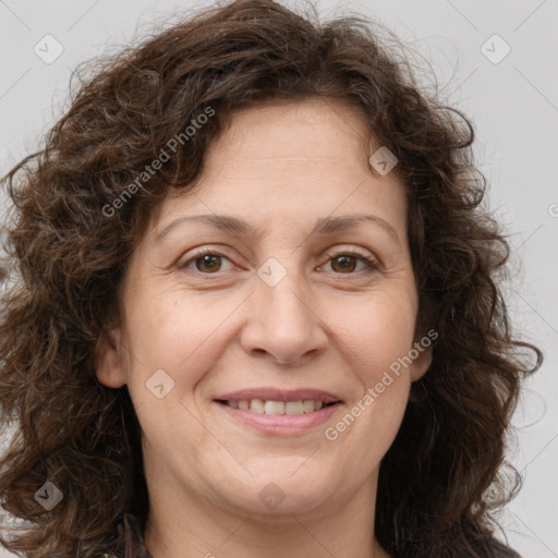 Joyful white adult female with long  brown hair and brown eyes