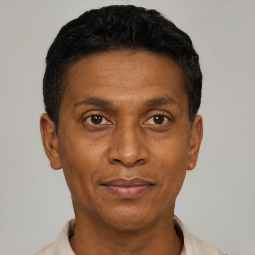 Joyful latino adult male with short  black hair and brown eyes