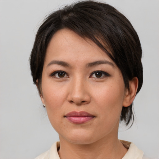 Joyful asian young-adult female with short  brown hair and brown eyes