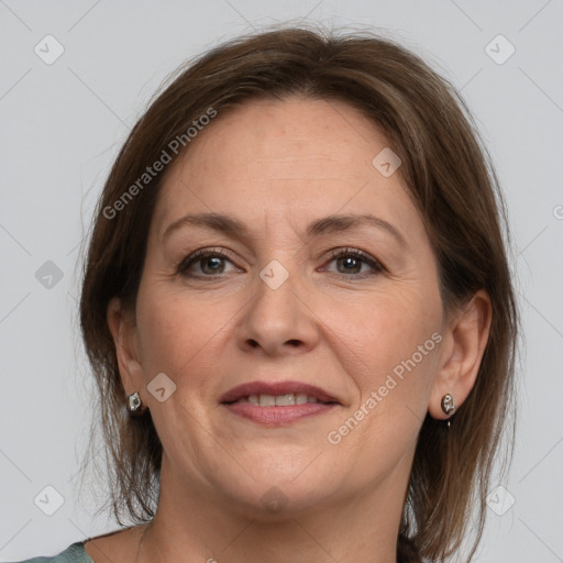 Joyful white adult female with medium  brown hair and grey eyes