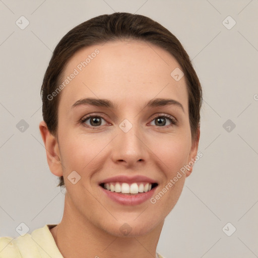 Joyful white young-adult female with short  brown hair and grey eyes