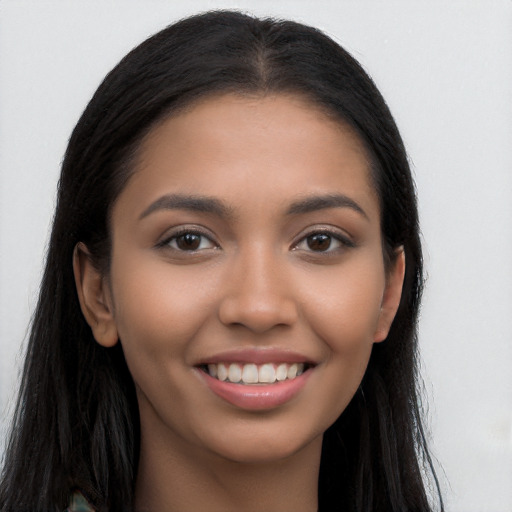 Joyful latino young-adult female with long  black hair and brown eyes