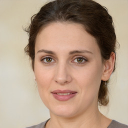 Joyful white young-adult female with medium  brown hair and green eyes