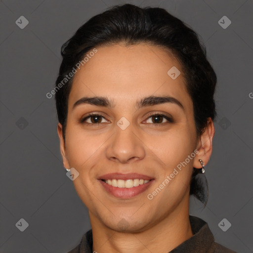 Joyful latino young-adult female with short  black hair and brown eyes