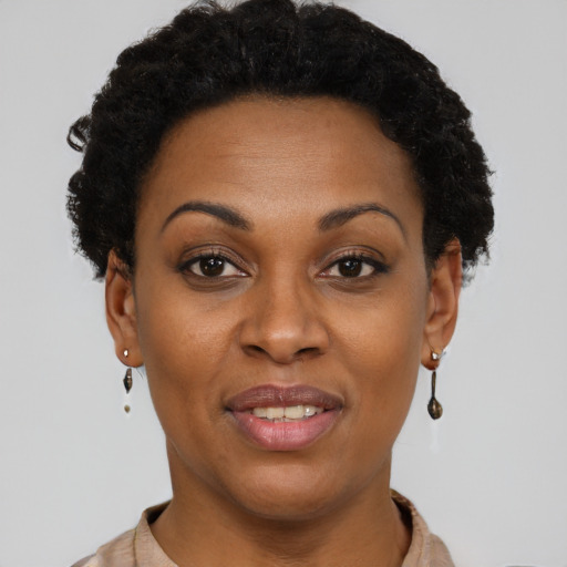 Joyful black young-adult female with short  brown hair and brown eyes