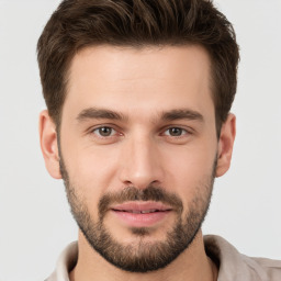 Joyful white young-adult male with short  brown hair and brown eyes