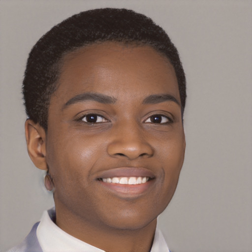 Joyful black young-adult male with short  brown hair and brown eyes