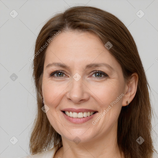 Joyful white adult female with long  brown hair and brown eyes