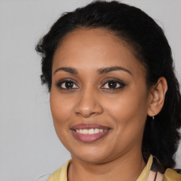 Joyful latino young-adult female with medium  black hair and brown eyes