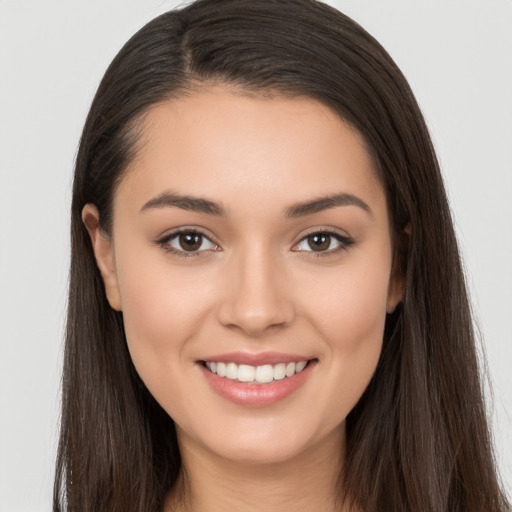 Joyful white young-adult female with long  brown hair and brown eyes