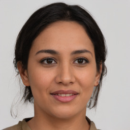 Joyful latino young-adult female with medium  brown hair and brown eyes