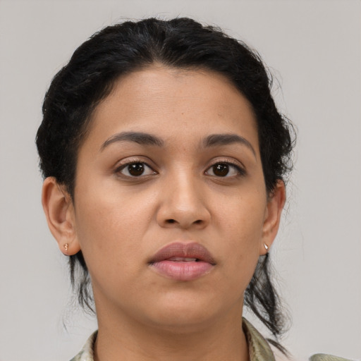 Joyful latino young-adult female with medium  black hair and brown eyes