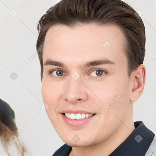 Joyful white young-adult male with short  brown hair and brown eyes