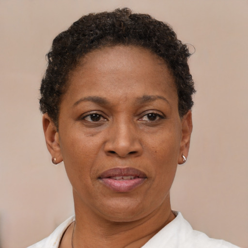 Joyful black adult female with short  brown hair and brown eyes