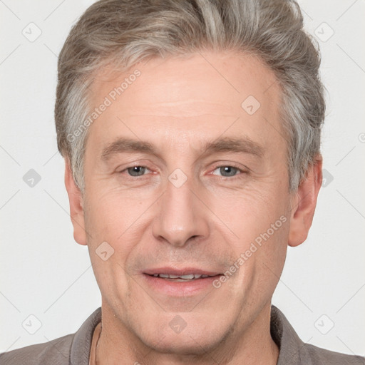 Joyful white adult male with short  brown hair and grey eyes