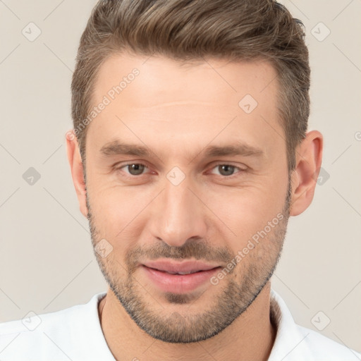 Joyful white young-adult male with short  brown hair and brown eyes