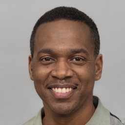 Joyful latino adult male with short  black hair and brown eyes