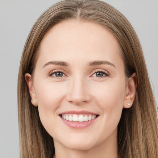 Joyful white young-adult female with long  brown hair and grey eyes