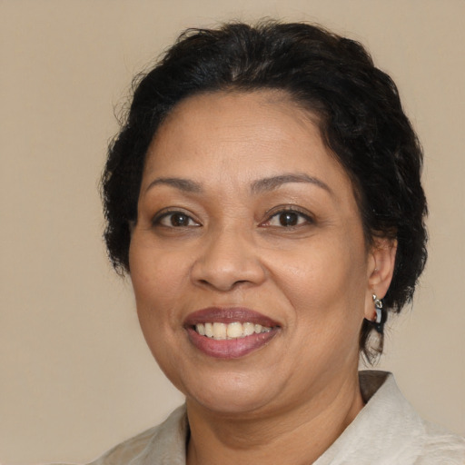 Joyful latino adult female with medium  brown hair and brown eyes