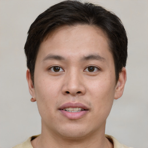 Joyful white young-adult male with short  brown hair and brown eyes