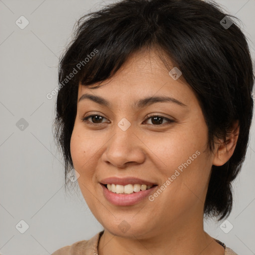 Joyful asian young-adult female with medium  brown hair and brown eyes