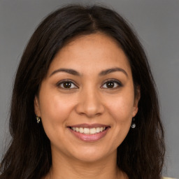 Joyful white young-adult female with long  brown hair and brown eyes